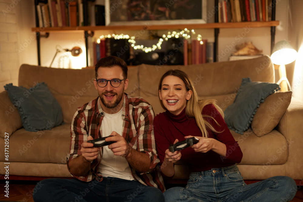 Young couple having fun at home playing video games Young couple having fun at home playing video games