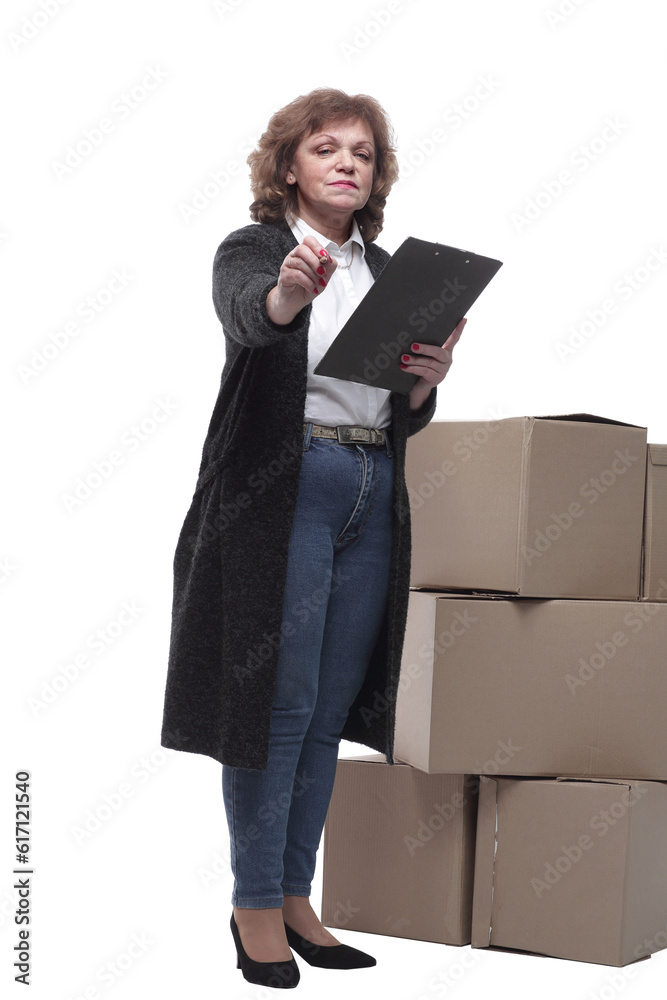in full growth. serious woman signs documents after delivery. in full growth. serious woman signs documents after delivery.