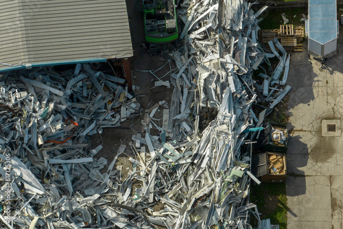 Beg pile of scrap aluminum metal siding from ruined houses after hurricane Ian swept through Florida. Recycle of broken parts of mobile homes photo