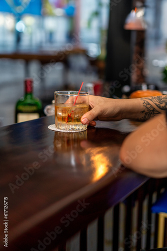 person drinking wiskey in bar