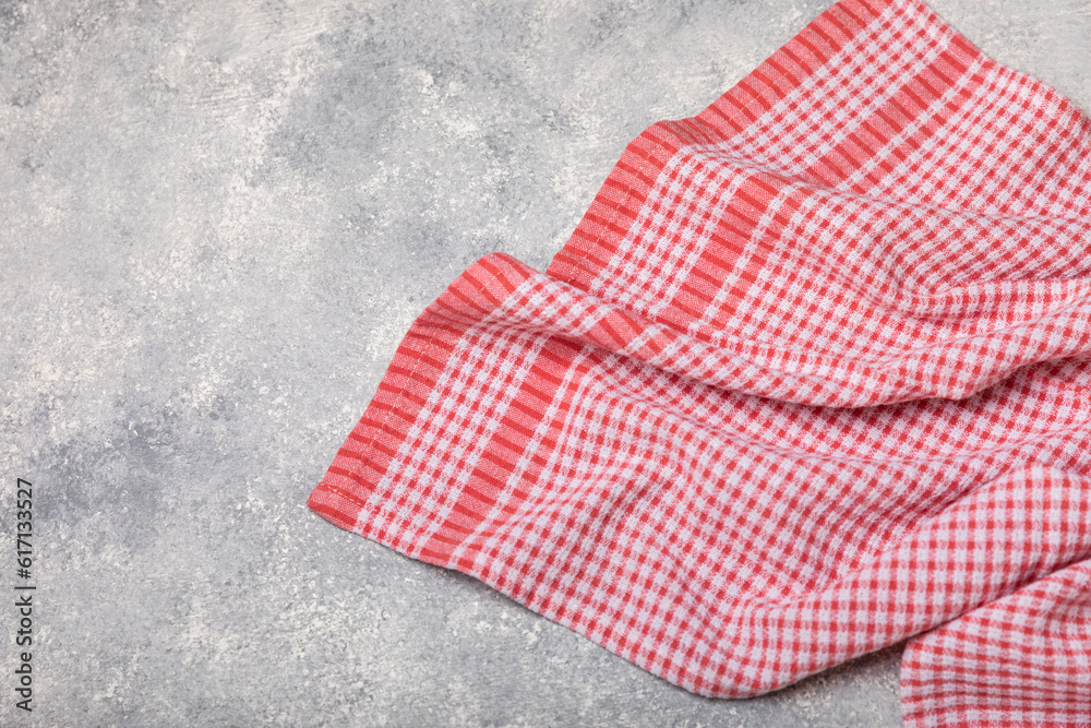 Kitchen towels on a marble background. New kitchen cotton towels on the kitchen table. Red checkered picnic napkin. Home textiles. Place for text. copy space.