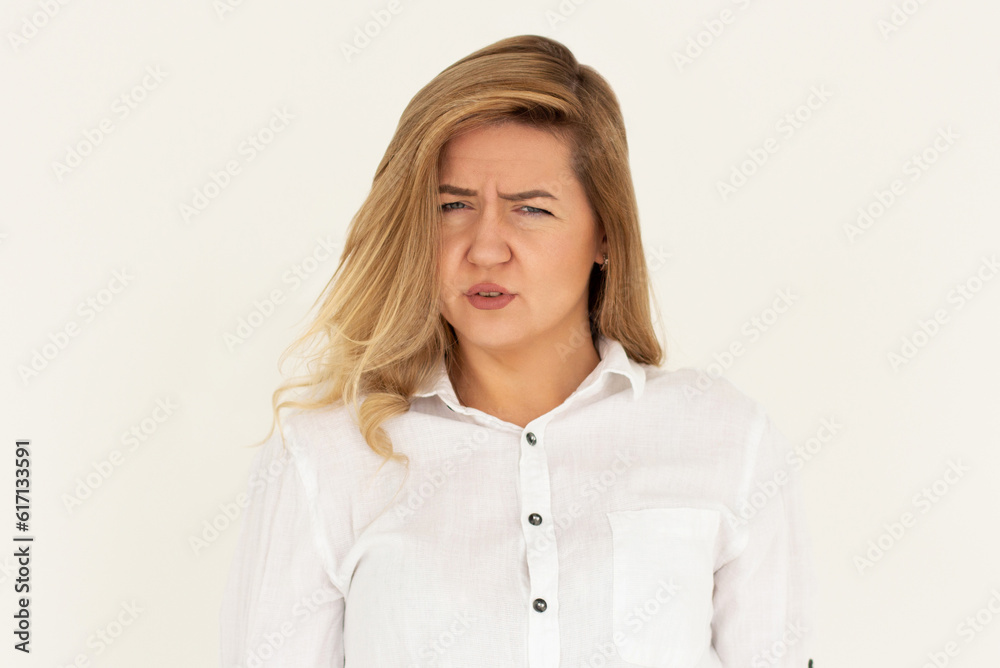 Studio shot of cute girl with fair hair and confused face isolated on white background Studio shot of cute girl with fair hair and confused face isolated on white background