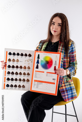 girl holding a palette of hair colors
