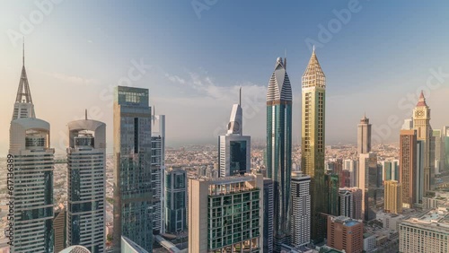 Skyline view of the high-rise buildings on Sheikh Zayed Road in Dubai aerial timelapse, UAE. Skyscrapers in International Financial Centre financial hub from above. Villa houses on a background photo