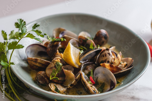 Mussels in a Green Pastel Bowl with Fresh Salsa Leaves and Peppers © Daniel
