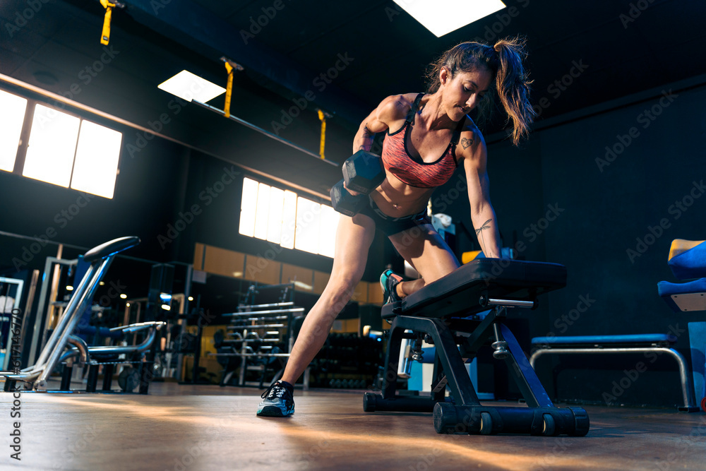 Fitness Pro: Middle-aged Woman Leading Intense Gym Workout