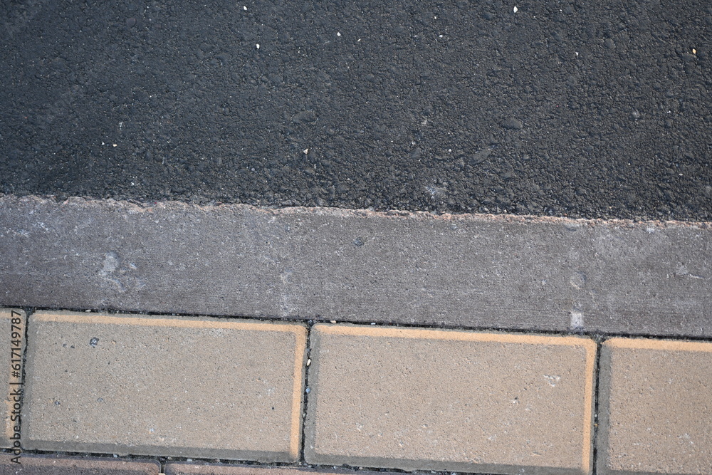Fototapeta premium Close-up of a sidewalk and road markings, bike path, blind lane, pedestrian crossing, road texture, paving slabs