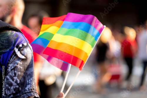 Bandeirolas símbolo do orgulho gay nas mão de vendedores ambulantes na  27ª edição, da Parada do Orgulho LGBT+ de São Paulo, Avenida Paulista, Brasil.  photo