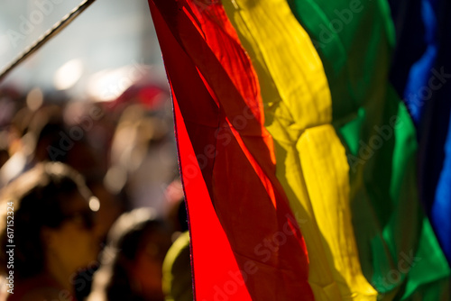 Bandeira símbolo do orgulho gay e publico ao fundo. 27ª edição, Parada do Orgulho LGBT+ de São Paulo, Brasil.  photo