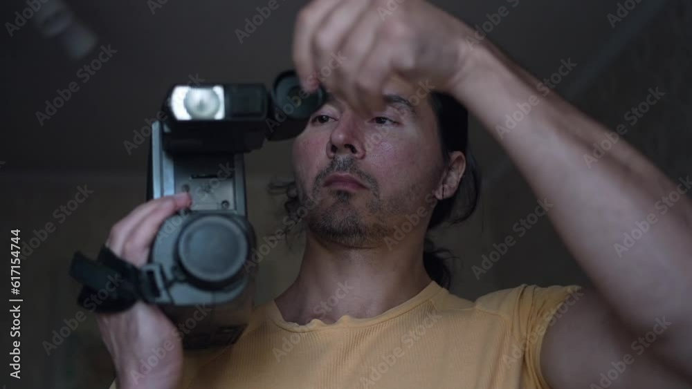 A handsome cameraman with a retro camcorder, man with camera. Slow motion A handsome cameraman with a retro camcorder, man with camera. Slow motion