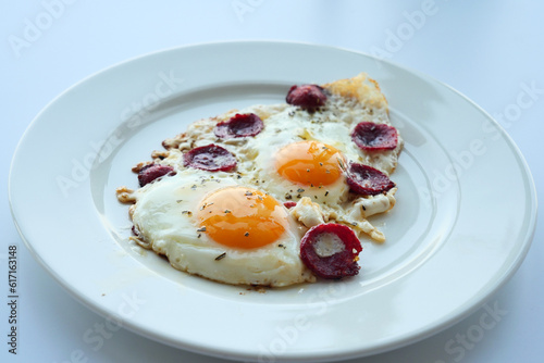 fried egg mixed with sausage on a plate 