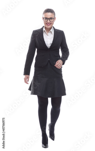 in full growth. smiling businesswoman confidently striding forward