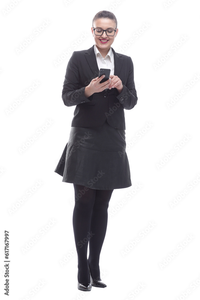 in full growth. smiling businesswoman reading a message on her smartphone. in full growth. smiling businesswoman reading a message on her smartphone.