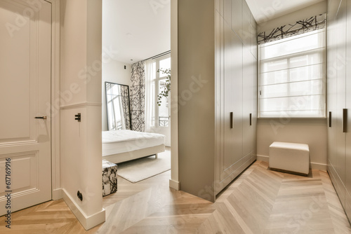 a bedroom with white walls and wood flooring in the middle of the room  there is a mirror on the wall