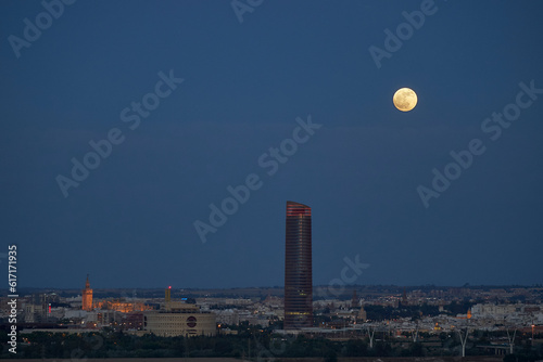Seville skyline and its full moon.