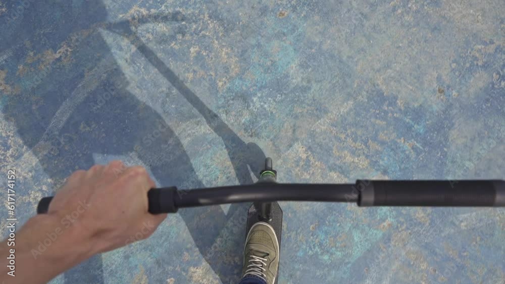 rider rides a stunt scooter in a skatepark