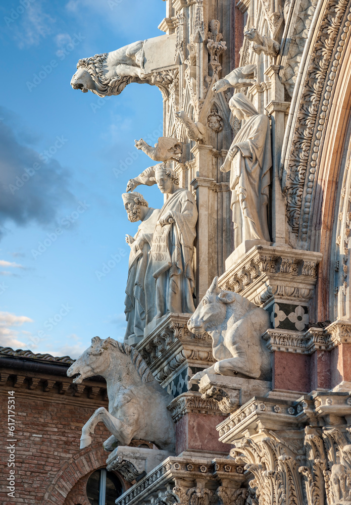 Detail of the Santa Maria Assunta cathedral facade, with allegoric sculpture of animals, prophet and philosophers