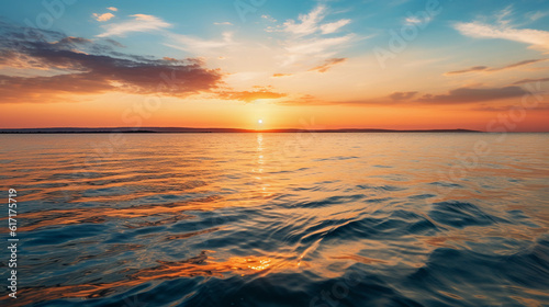 Stunning golden sunset over a calm sea  with slight ripples on the water surface  reflected sunlight  serene and tranquil mood