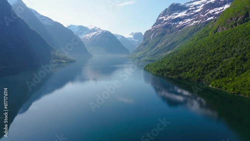 Drone flyby over Lovatnet, Loen. Snowy Mountains and glacier water.  photo