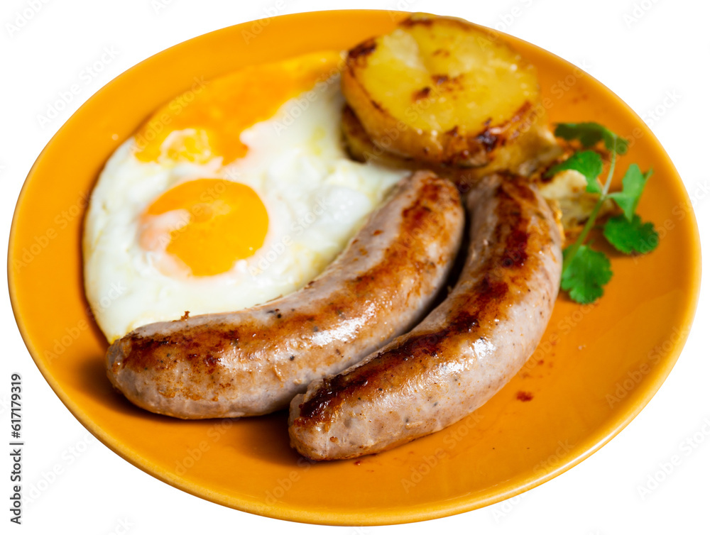 Two delicious fried sausages with fried eggs, sliced potatoes and decorated with a fresh sprig of parsley. Isolated over white background