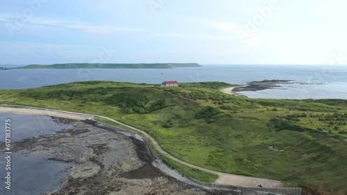 Aerial travelling of Penghu island coastline. View of lone house near the shore in Tawain tourist travel destination. photo