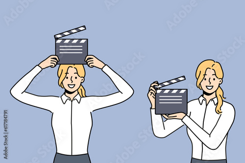 Woman with clapboard for shooting movie works in hollywood film company and dreams of becoming film director. Girl with clapboard to help filming blockbuster demonstrates equipment for recording takes