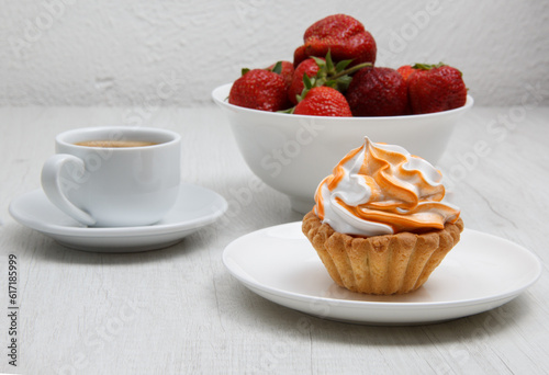 cake with coffee and strawberry cream on a wooden table. selective focus