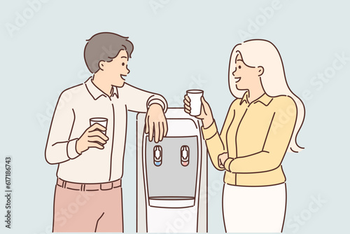 Conversation of employees near office cooler and exchange of views between colleagues during break