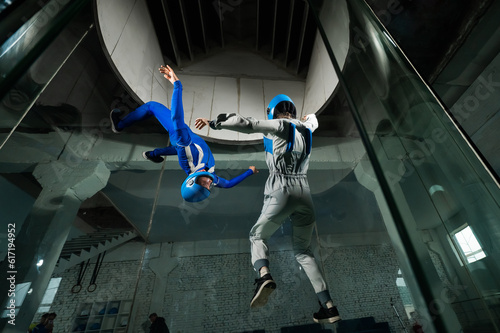 A man and a woman enjoy flying together in a wind tunnel. Free fall simulator