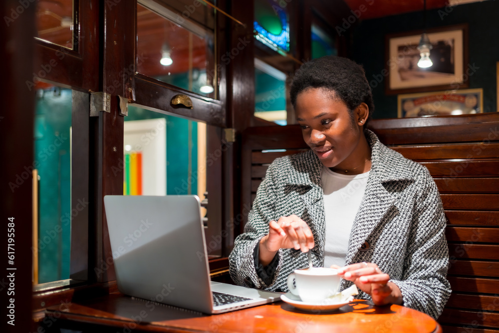 Business woman of African ethnicity in a coffee shop, moment of rest finance woman having a coffee Business woman of African ethnicity in a coffee shop, moment of rest finance woman having a coffee