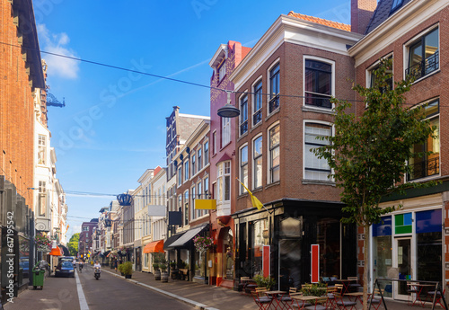 Εκτύπωση καμβά View of historical district of Old Town The Hague overlooking narrow picturesque street with old buildings, shops and open air restaurants on sunny summer day, Netherlands