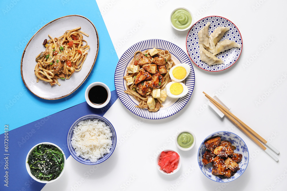 Composition with tasty Chinese dishes and chopsticks on light background Composition with tasty Chinese dishes and chopsticks on light background