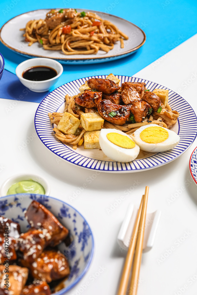 Plates with tasty Chinese food on light background Plates with tasty Chinese food on light background