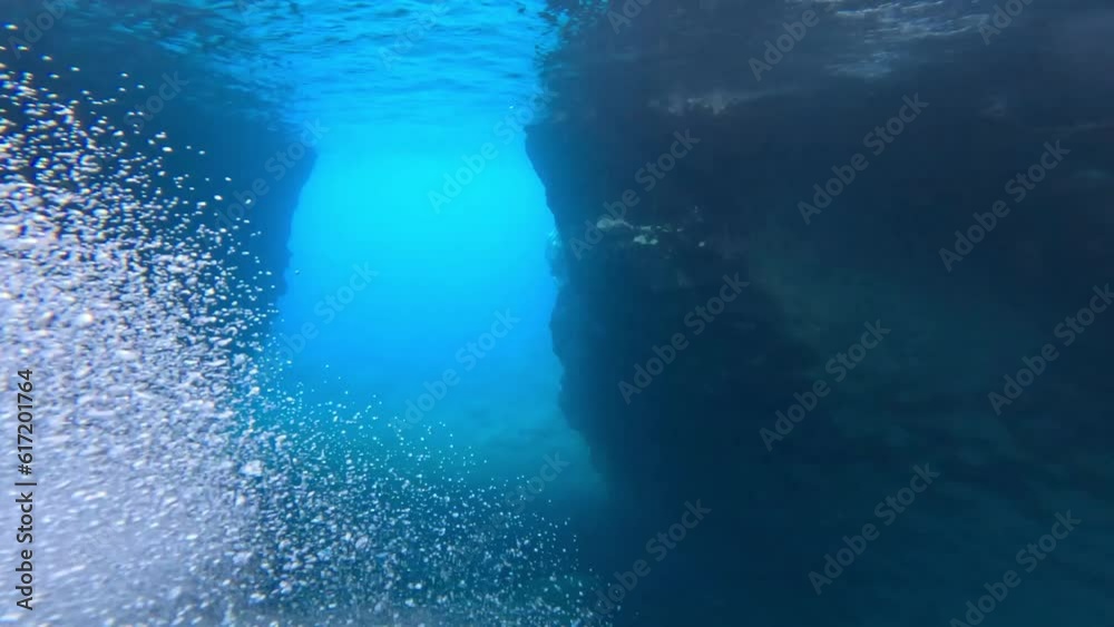 Point of view of person walking and jumping off from the cliff to the water of an amazing beach in Tenerife, Spain. Lifestyle concept and vacations free time.