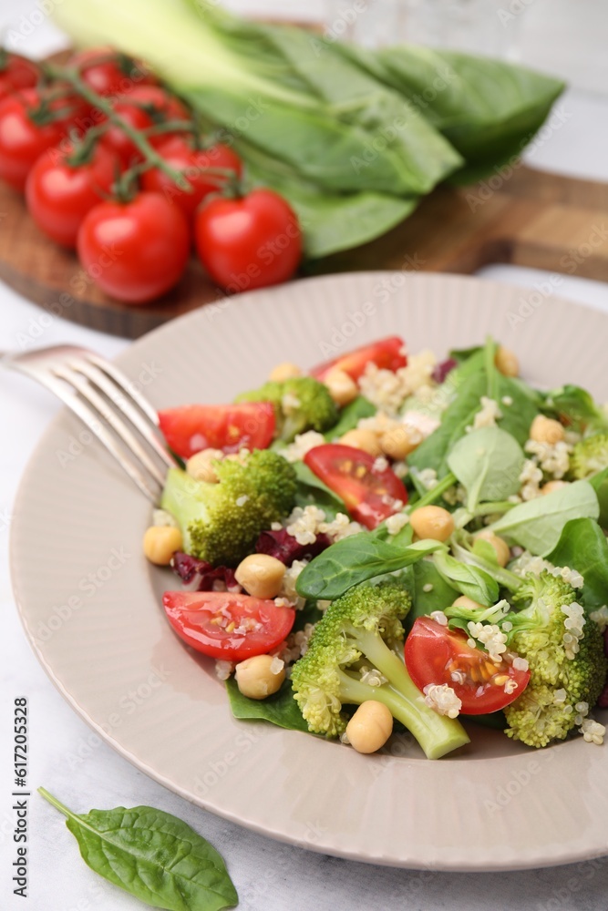 Healthy meal. Tasty salad with quinoa, chickpeas and vegetables served on table, closeup