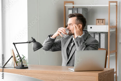 Young businessman drinking ...