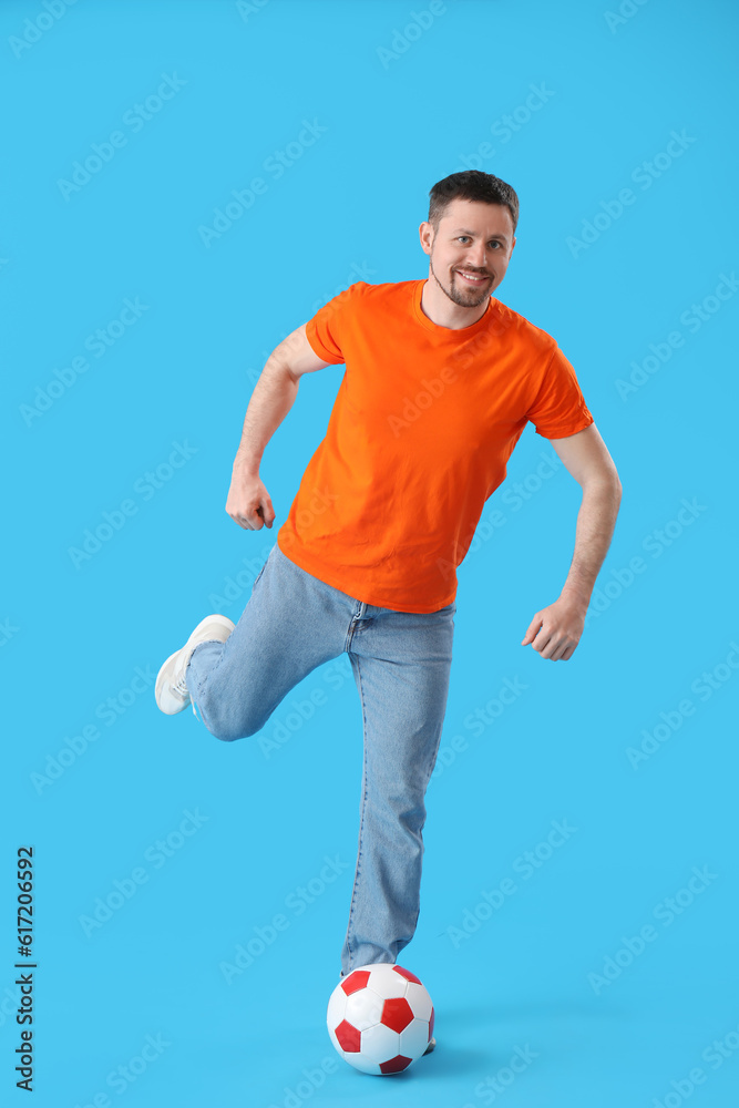 Man playing with soccer ball on blue background Man playing with soccer ball on blue background