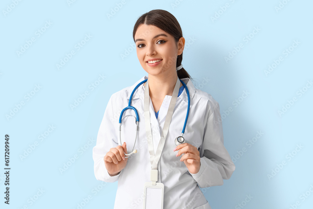 Female doctor with stethoscope on blue background Female doctor with stethoscope on blue background