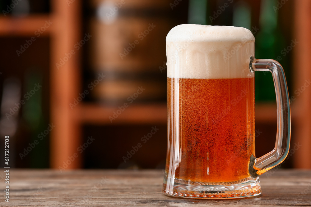 Mug of beer on table in bar. Oktoberfest celebration