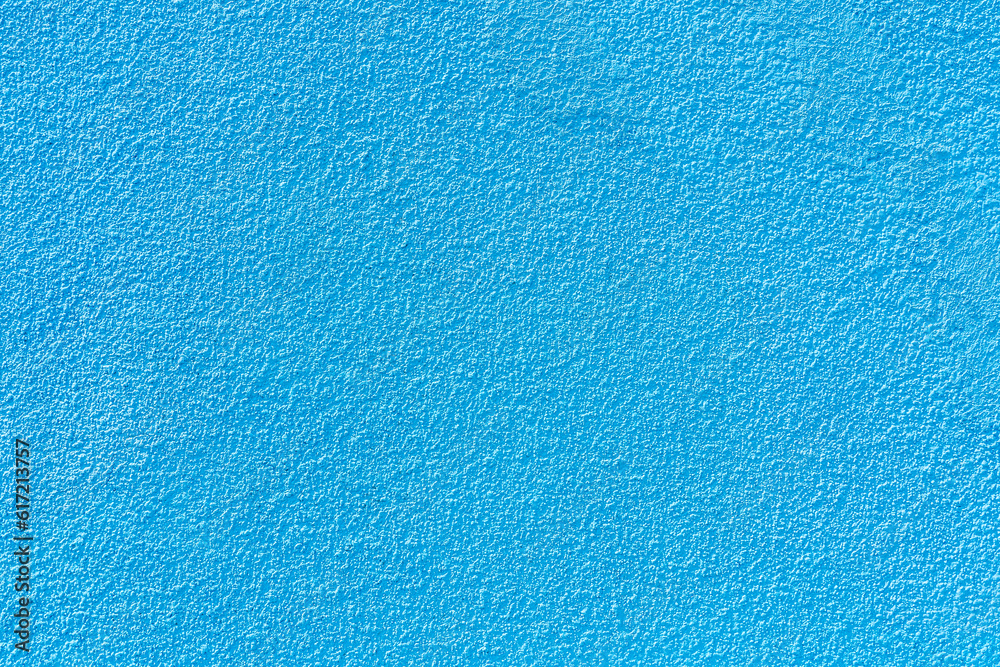 Rough textural surface of a blue wall. Background or backdrop. Blank for design Rough textural surface of a blue wall. Background or backdrop. Blank for design