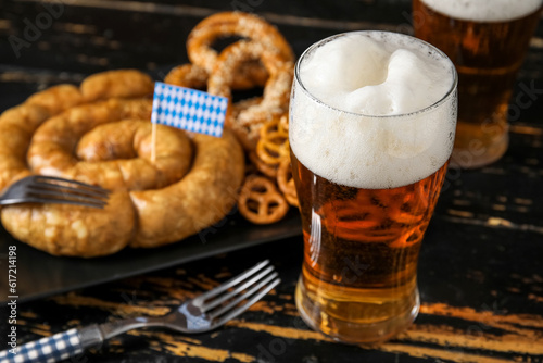Glass of cold beer on dark wooden background. Oktoberfest celebration