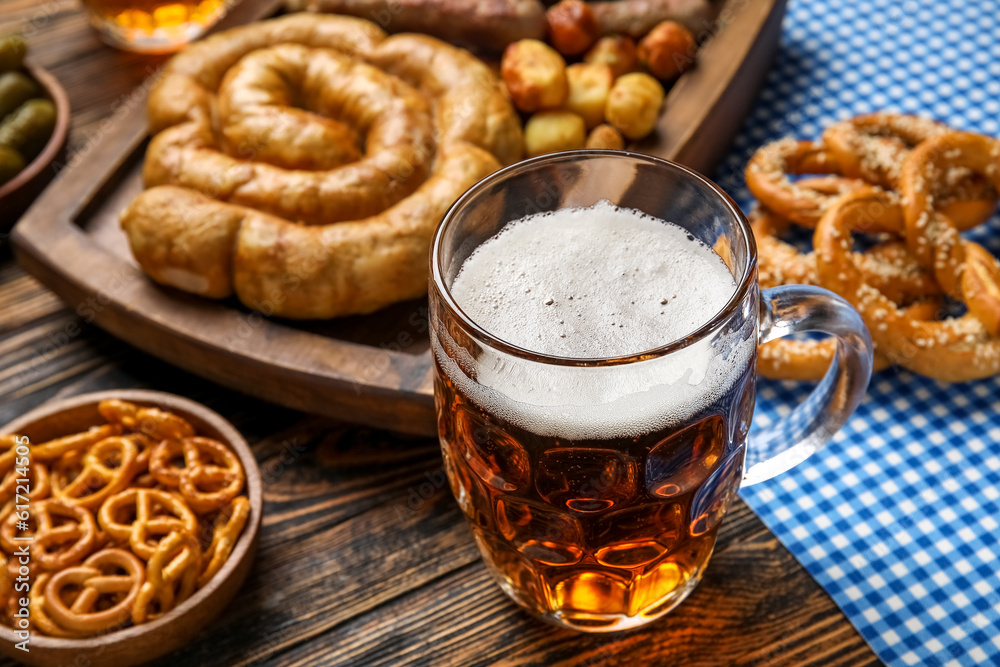 Mug of cold beer on wooden background. Oktoberfest celebration Mug of cold beer on wooden background. Oktoberfest celebration