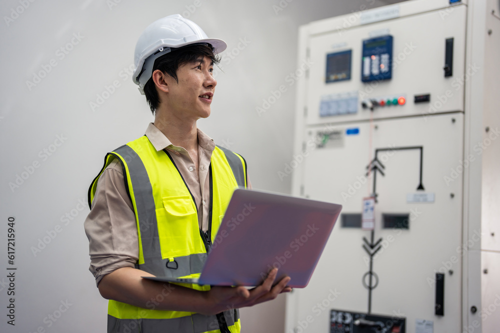 Asian attractive man industrial worker working in manufacturing plant. Asian attractive man industrial worker working in manufacturing plant.