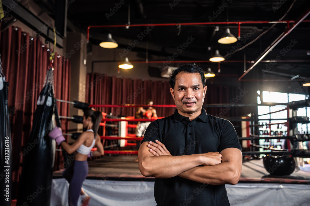 Portrait of Asian male referee enforces the rules of the boxing match. 