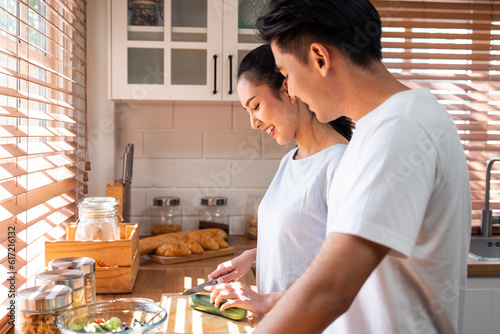 Asian young new marriage couple spend time together in kitchen at home. 