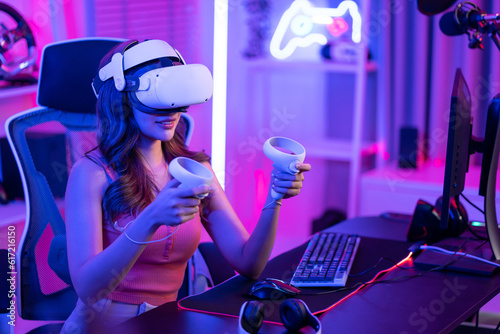 Asian young Esport woman gamer use technology VR glasses and play game. 