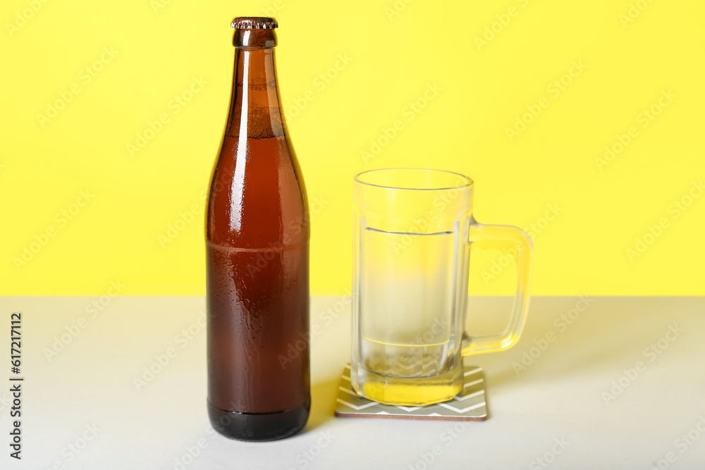 Bottle of cold beer and mug on color background Bottle of cold beer and mug on color background