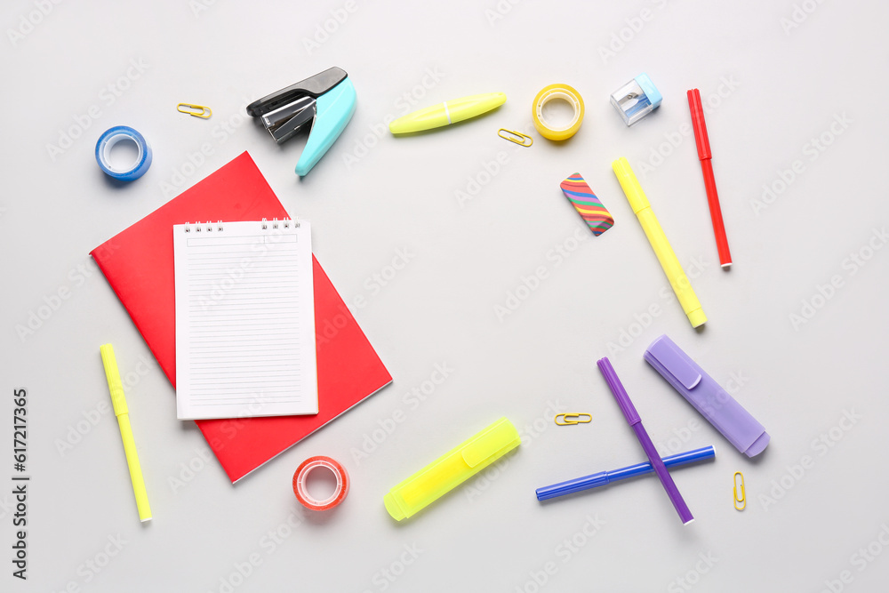 Notebooks with different school stationery on white background Notebooks with different school stationery on white background