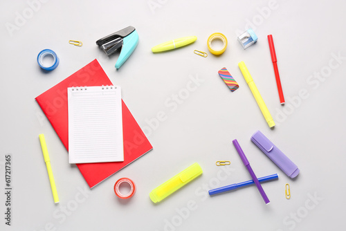 Notebooks with different school stationery on white background