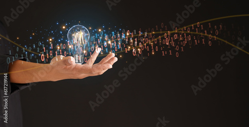 Creative solution or idea for web banner design or landing page template for a creative agency with a hand coming out of the screen with a colorful light bulb and leading line with numbers 0110.